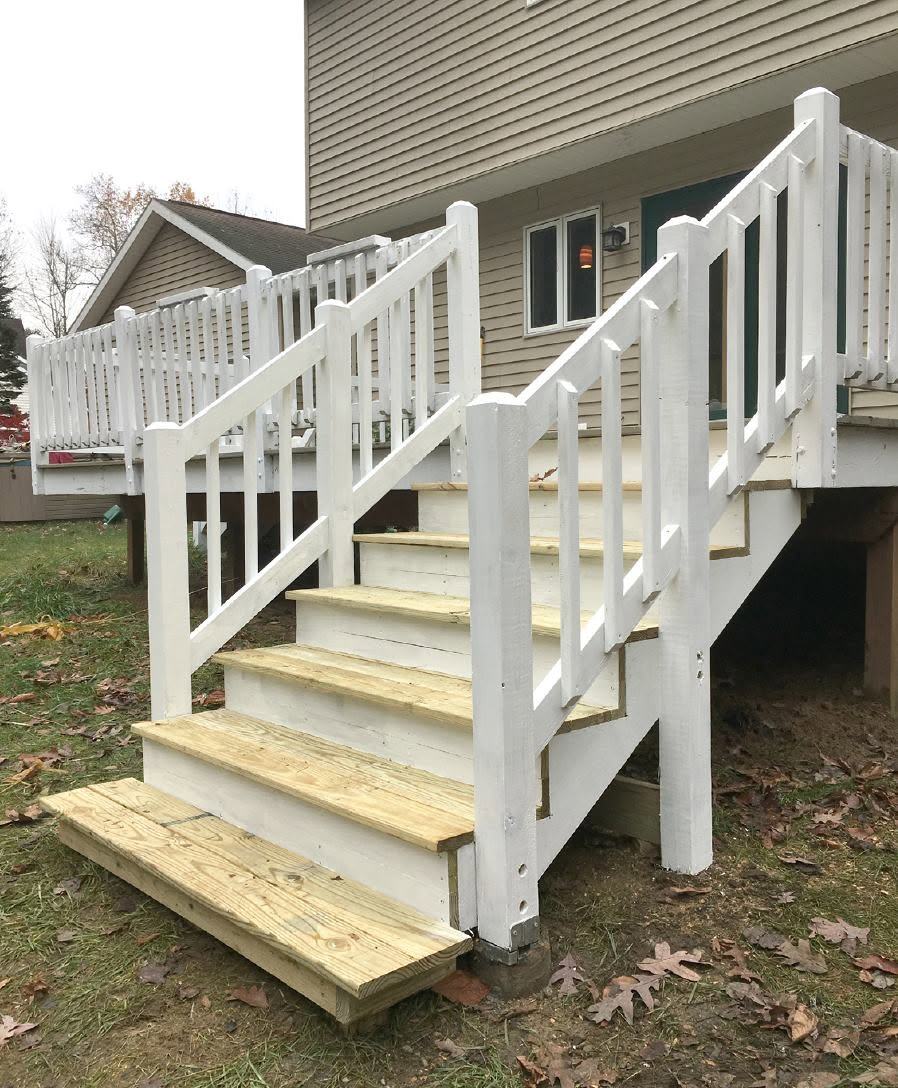 White vinyl deck rail with new pressure-treated stair treads